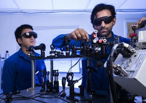 Bolin Liao and student in lab working on optical bench