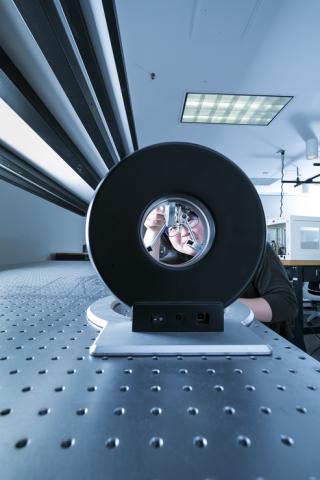 person working on optical bench